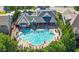 Overhead shot of the community pool area, featuring a large pool, lounge chairs, and surrounding houses and trees at 3883 Wakefield Hall Se Sq, Smyrna, GA 30080