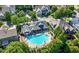 Aerial view of the community pool, showcasing its unique shape and surrounding greenery and nearby houses at 3883 Wakefield Hall Se Sq, Smyrna, GA 30080