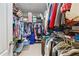 View of a large walk-in closet with hanging clothes, shelves with shoes, and storage containers at 3883 Wakefield Hall Se Sq, Smyrna, GA 30080
