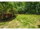 Private backyard with green grass and mature trees at 4047 Jordan Lake Dr, Marietta, GA 30062