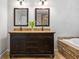 Double vanity with granite countertops, dark cabinets, and tile flooring, and soaking tub at 4047 Jordan Lake Dr, Marietta, GA 30062