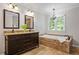 Primary bathroom with tile flooring, soaking tub, and granite countertops on the dark vanity at 4047 Jordan Lake Dr, Marietta, GA 30062