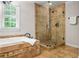 Modern bathroom boasts a glass shower, soaking tub, and tiled surround, offering a spa-like experience at 4047 Jordan Lake Dr, Marietta, GA 30062
