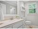 Light and airy bathroom showcases a white vanity, tile flooring, and a bright window at 4047 Jordan Lake Dr, Marietta, GA 30062