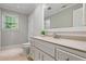 Bathroom with white vanity, tile flooring, and a window for natural light, plus a standard toilet at 4047 Jordan Lake Dr, Marietta, GA 30062