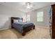 Comfortable bedroom with wood furnishings, two windows and neutral colored walls at 4047 Jordan Lake Dr, Marietta, GA 30062