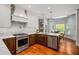 Well-lit kitchen showcases stainless appliances, a marble backsplash, and skylight at 4047 Jordan Lake Dr, Marietta, GA 30062