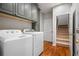 Convenient laundry room features a washer, dryer, and ample cabinet space at 4047 Jordan Lake Dr, Marietta, GA 30062