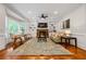 Cozy living room boasts a fireplace with built-in shelves, large windows, and hardwood floors at 4047 Jordan Lake Dr, Marietta, GA 30062