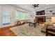 Bright living room features a brick fireplace, built-in shelving, and a large bay window at 4047 Jordan Lake Dr, Marietta, GA 30062