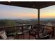 Covered back deck with outdoor furniture overlooking a scenic mountain view at sunset at 413 Horizon Trl, Canton, GA 30114