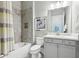 Charming bathroom with stylish gray vanity, framed mirror, shower-tub combination and tiled walls at 413 Horizon Trl, Canton, GA 30114