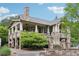 Stone clubhouse boasts a spacious porch, stone columns, and a stone chimney at 413 Horizon Trl, Canton, GA 30114