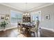 Inviting dining room with hardwood floors, chandelier, and natural light from the adjacent french doors at 413 Horizon Trl, Canton, GA 30114
