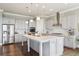 Stylish kitchen featuring gray cabinets, a large island, stainless appliances and hardwood floors at 413 Horizon Trl, Canton, GA 30114
