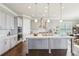 Bright kitchen featuring gray cabinets, a large island, stainless appliances, and hardwood floors at 413 Horizon Trl, Canton, GA 30114