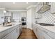 Modern kitchen featuring gray cabinets, a large island, stainless appliances and hardwood floors at 413 Horizon Trl, Canton, GA 30114