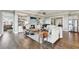 Open concept living room featuring hardwood floors, fireplace, and views of the connecting rooms at 413 Horizon Trl, Canton, GA 30114