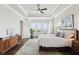 A primary bedroom with a tray ceiling, light walls, and a large window overlooking a serene outdoor view at 413 Horizon Trl, Canton, GA 30114