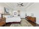 Spacious main bedroom with a ceiling fan, and neutral decor, leading into the ensuite bathroom at 413 Horizon Trl, Canton, GA 30114