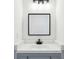 Elegant bathroom with a sleek mirror, stylish vanity, and modern fixtures at 10423 Commons Xing, Jonesboro, GA 30238