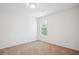 Comfortable carpeted bedroom with a window and natural light at 10423 Commons Xing, Jonesboro, GA 30238
