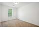 Comfortable carpeted bedroom with a window and natural light at 10423 Commons Xing, Jonesboro, GA 30238