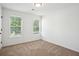 Bright carpeted bedroom with sunlit windows at 10423 Commons Xing, Jonesboro, GA 30238