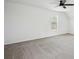 Spacious bedroom featuring neutral carpet, a ceiling fan, and a sunlit window at 10423 Commons Xing, Jonesboro, GA 30238