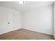 Carpeted bedroom with white door and walls offering a blank canvas at 10423 Commons Xing, Jonesboro, GA 30238