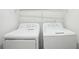 Bright laundry room features a standard washer and dryer set and wire shelving for convenient storage at 10423 Commons Xing, Jonesboro, GA 30238