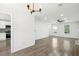 Bright living room featuring hardwood floors, modern lighting and views into the kitchen at 10423 Commons Xing, Jonesboro, GA 30238