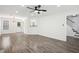 Open-concept living room with hardwood flooring and views of the staircase and kitchen at 10423 Commons Xing, Jonesboro, GA 30238