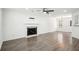 Spacious living room with hardwood flooring, modern fireplace and neutral colors at 10423 Commons Xing, Jonesboro, GA 30238