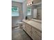 Well-lit bathroom featuring a white vanity, modern fixtures, and a shower/tub combo at 1513 Wildwood Dr, Acworth, GA 30102
