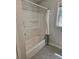 Clean bathroom showcasing a shower/tub combo with white tile and built-in shelving at 1513 Wildwood Dr, Acworth, GA 30102