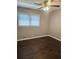 This bedroom features beautiful wood floors, a ceiling fan, and natural light from the window at 1513 Wildwood Dr, Acworth, GA 30102