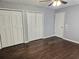 Bedroom with hardwood floors, ceiling fan, and ample closet space at 1513 Wildwood Dr, Acworth, GA 30102