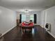 Large game room with a pool table, hardwood floors, and natural light from the windows at 1513 Wildwood Dr, Acworth, GA 30102