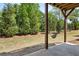 View to the green backyard from underneath covered patio with swing at 476 Springer Nw Bnd, Marietta, GA 30060