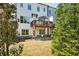 Charming backyard with a wooden deck, lower patio, mature trees, and well-maintained lawn at 476 Springer Nw Bnd, Marietta, GA 30060