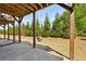 Backyard covered patio and swing, with view to the line of evergreens in the distance at 476 Springer Nw Bnd, Marietta, GA 30060