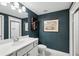 Stylish bathroom featuring a white vanity, subway tile shower, and navy blue accent wall at 476 Springer Nw Bnd, Marietta, GA 30060