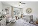 Bright Bedroom with a neutral color palette, featuring a crib, glider, and decorative shelving at 476 Springer Nw Bnd, Marietta, GA 30060