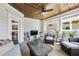 Cozy covered porch with a ceiling fan, TV, comfortable seating, and a view of the backyard at 476 Springer Nw Bnd, Marietta, GA 30060