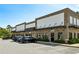 Commercial building exterior with brick facade, dark awnings, and ample parking spaces at 476 Springer Nw Bnd, Marietta, GA 30060
