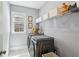 Well-lit laundry room with gray front-loading washer and dryer, and shelving for storage at 476 Springer Nw Bnd, Marietta, GA 30060