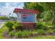 Welcome to Kennesaw Downtown sign surrounded by lush greenery in a well-maintained landscape at 476 Springer Nw Bnd, Marietta, GA 30060