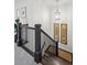Carpeted stairway with dark wood banister, natural light, and decorative artwork at 476 Springer Nw Bnd, Marietta, GA 30060