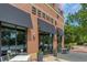 Inviting storefront with large windows, black awnings, and sidewalk seating at 476 Springer Nw Bnd, Marietta, GA 30060